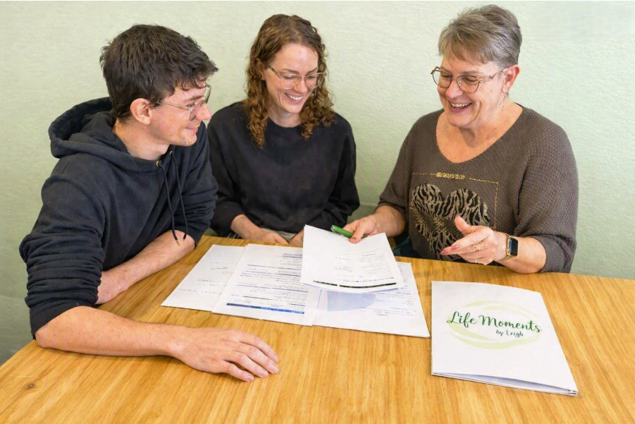 Leigh Mazzer with clients completing their first wedding paperwork appointment